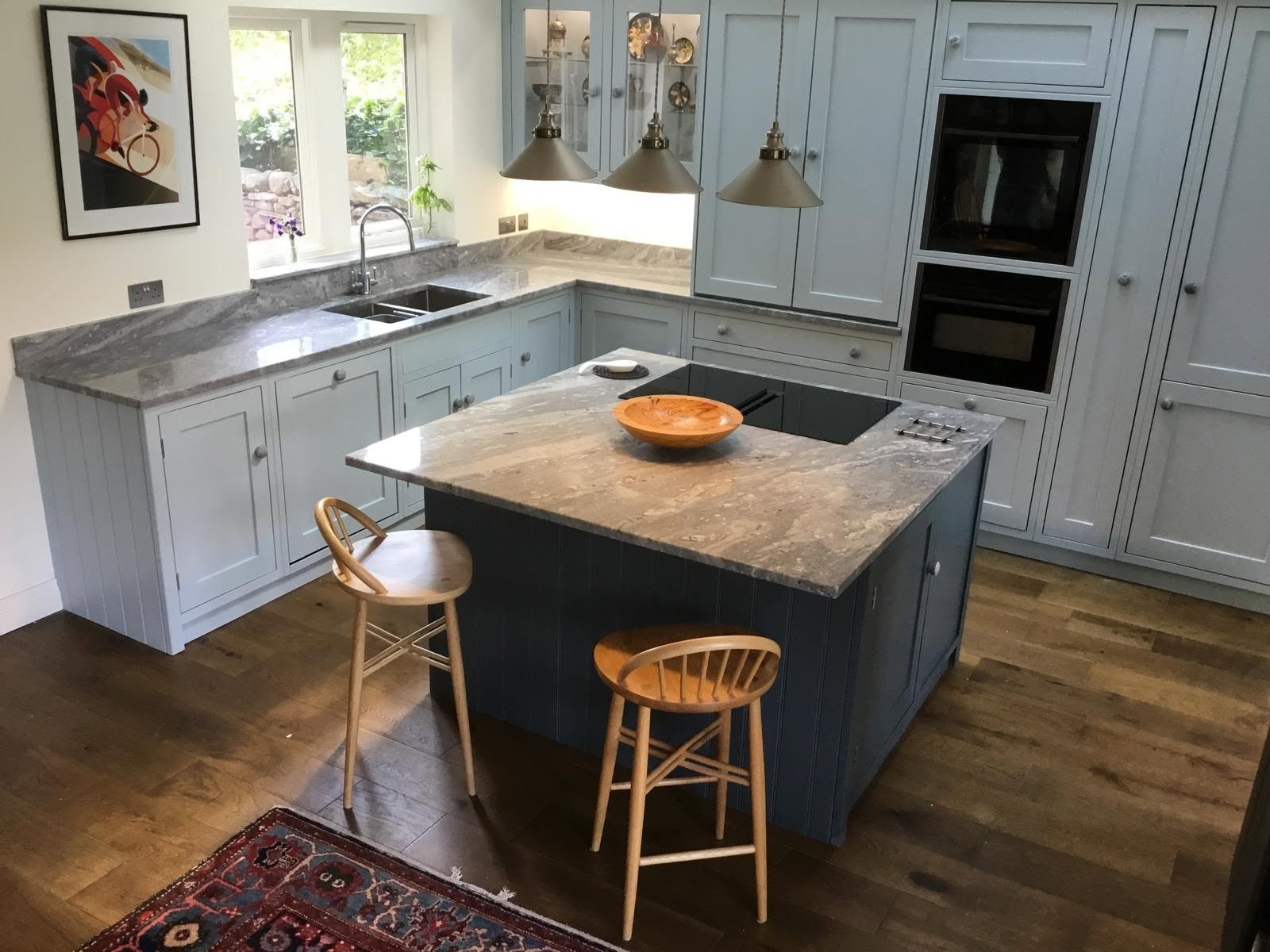 Painted in-frame kitchen with a dark blue island and granite worktop